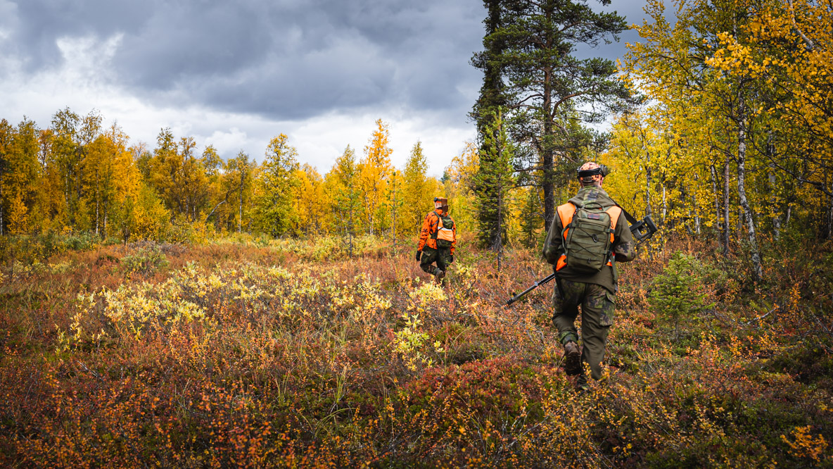 Two moose hunters in the forest in Lapland