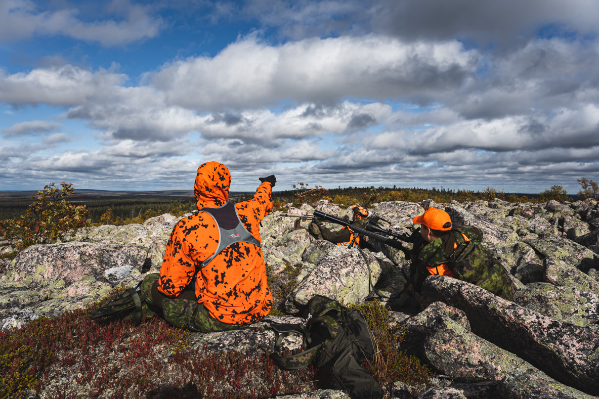 Two moose hunters on top of a fell in Lapland