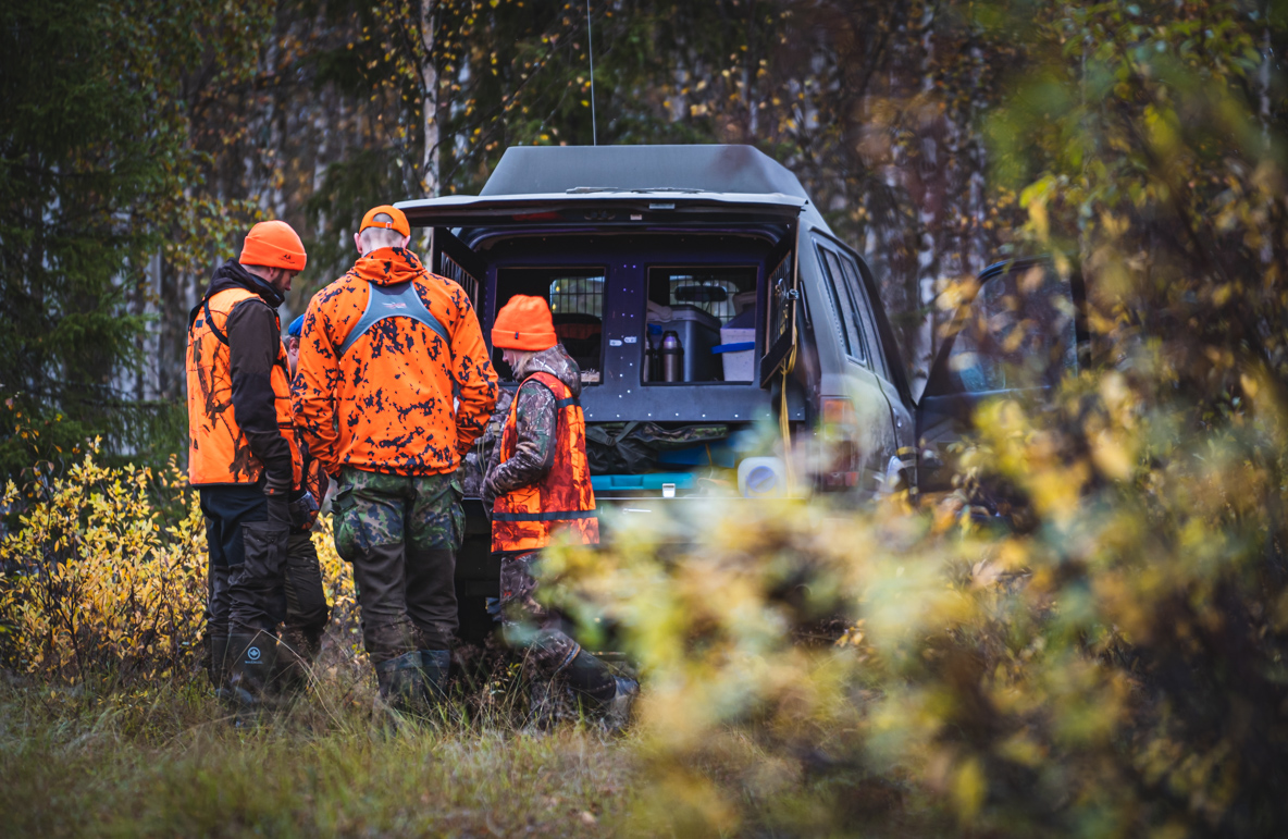 Three moose hunters following the hunting dog on the GPS