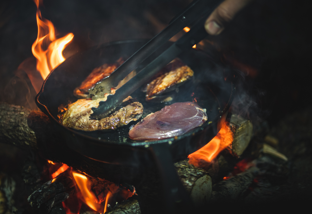 Frying forest bird breast on a cast iron pan