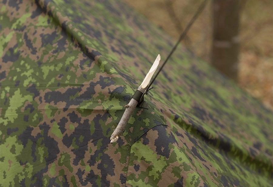 Guyline attached to a camo tarp loop