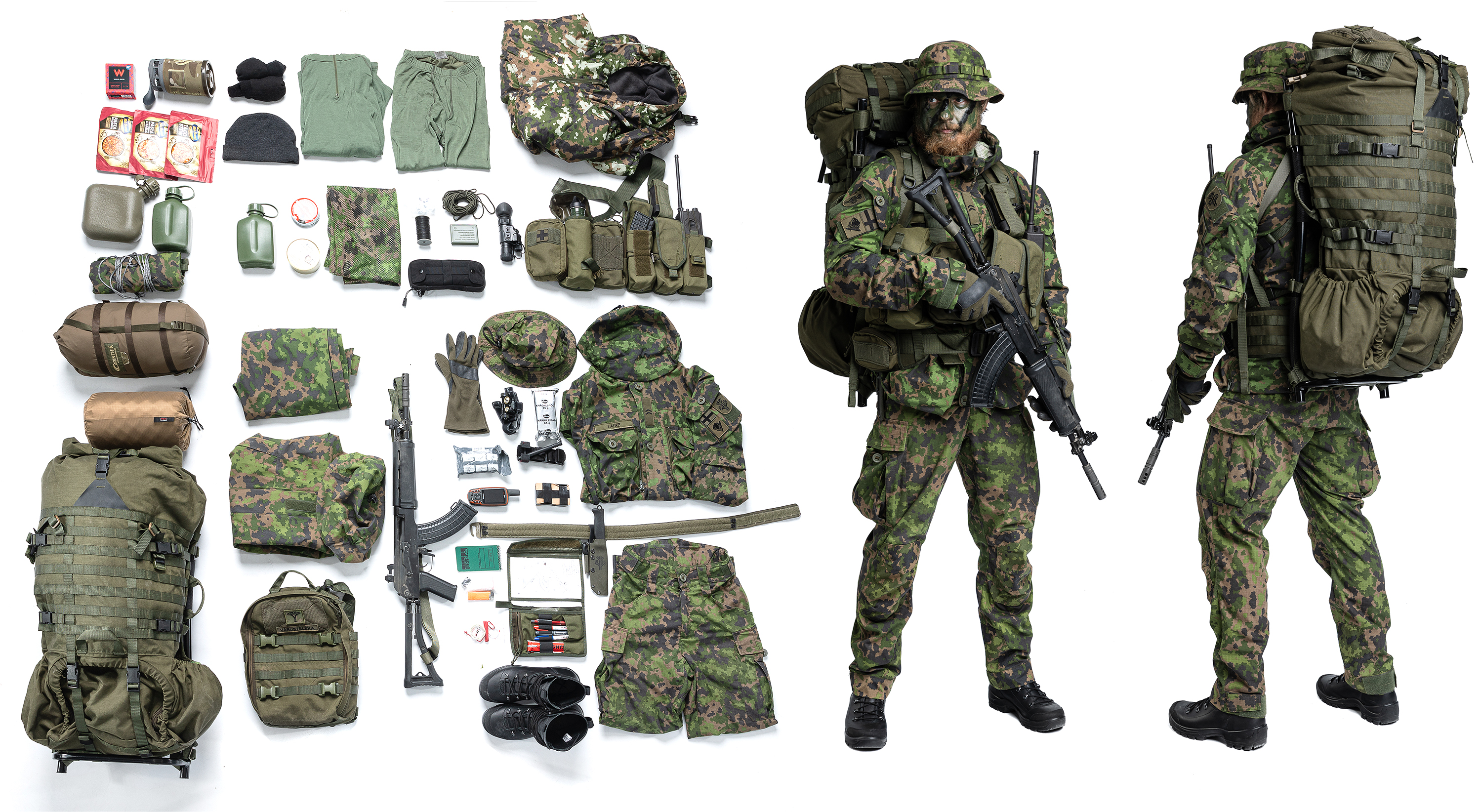 A man in Varusteleka gear wearing a backpack, and next to him there's the contents of the pack spread out.